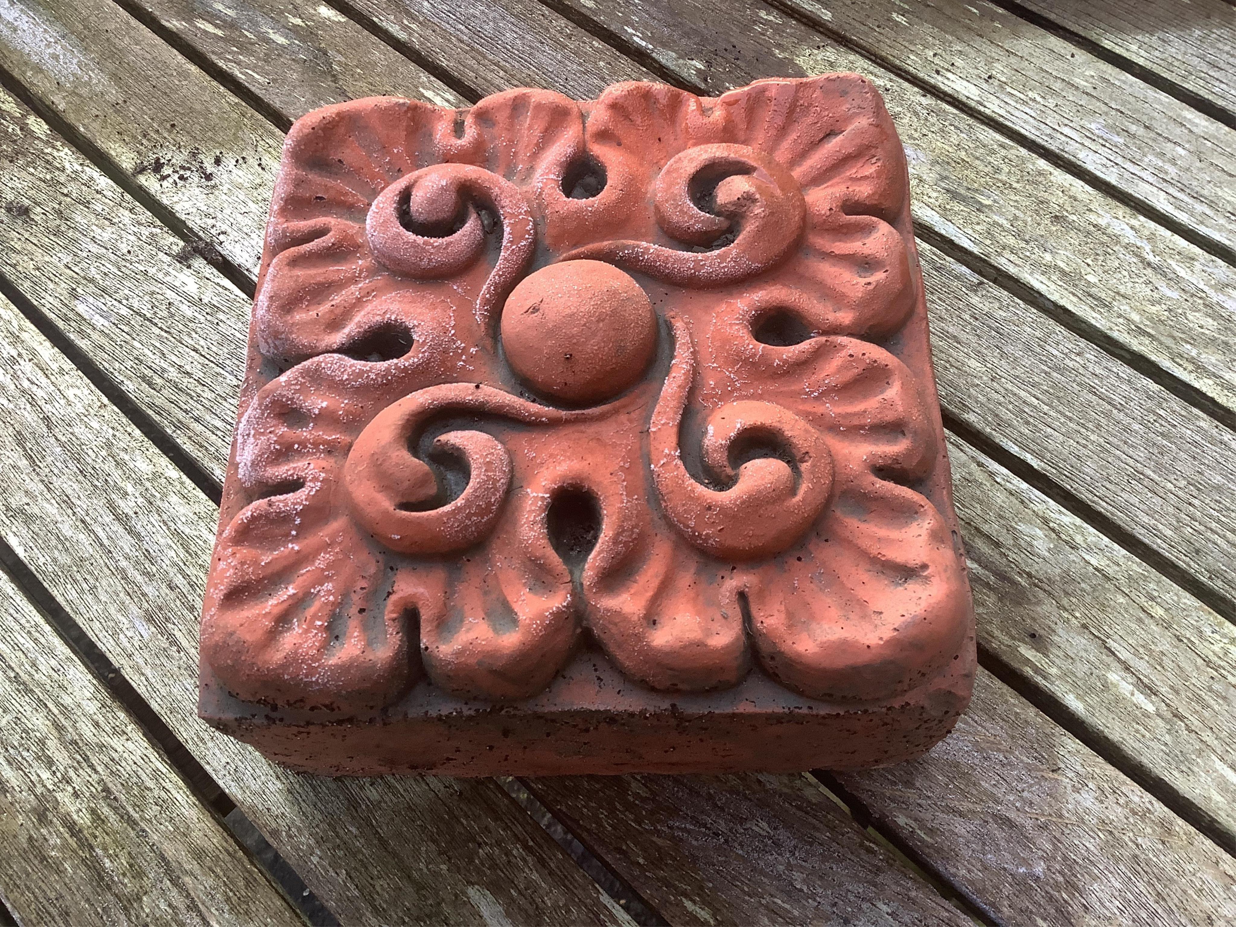 Six terracotta decorative tiles, largest width 21cm. Condition - fair